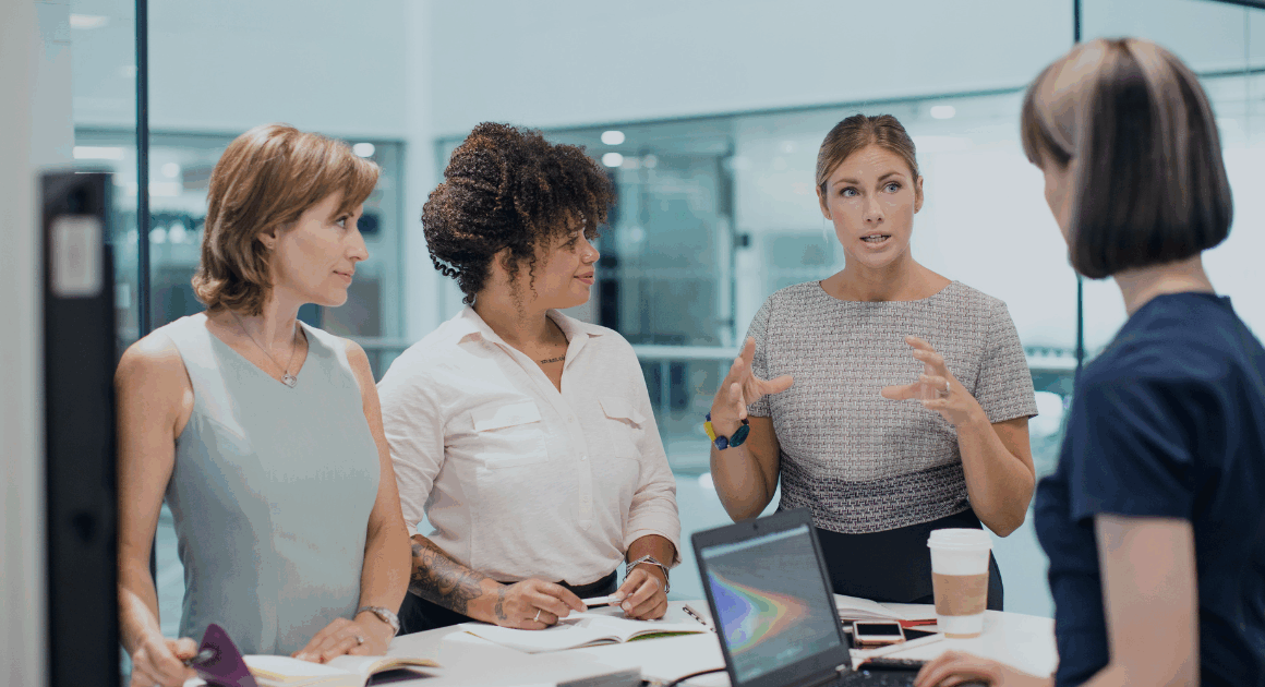 Engineers discussing SimPowerSystems simulation workflows in an office meeting.